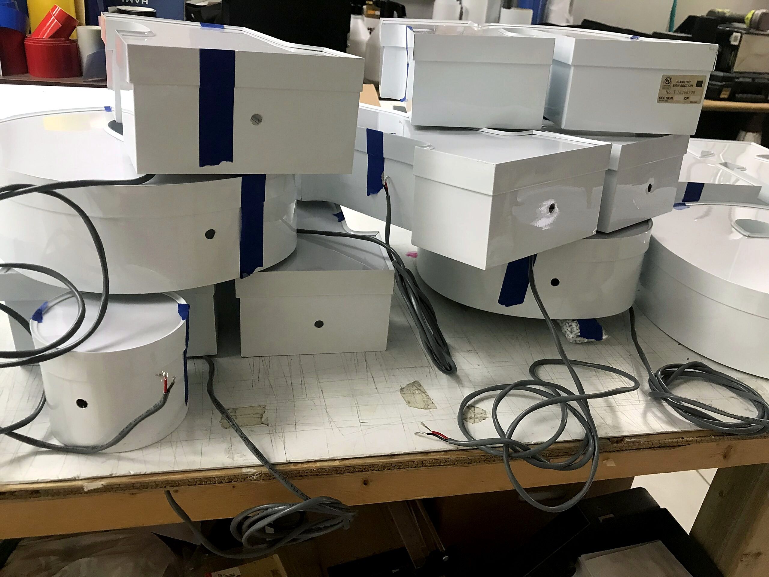 Channel letter returns with wiring on a shop workbench
