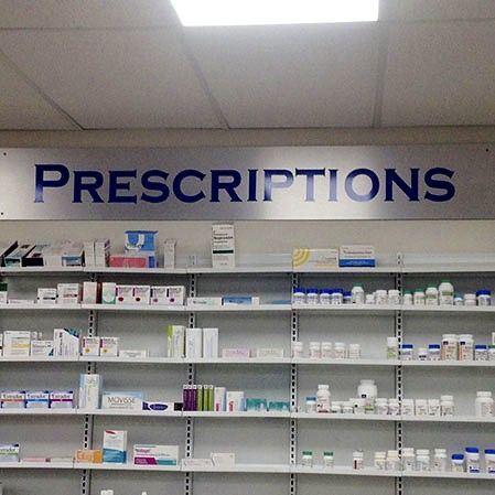 Prescriptions wall lettering above pharmacy shelving